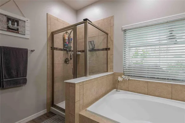 a bathroom with a bathtub and a shower