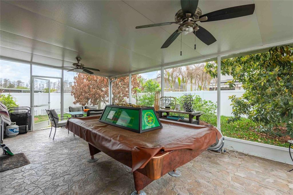 2814 Maple Brook Loop Lutz, FL 33558 - Photo 20 of 38 a living room with patio furniture and a floor to ceiling window