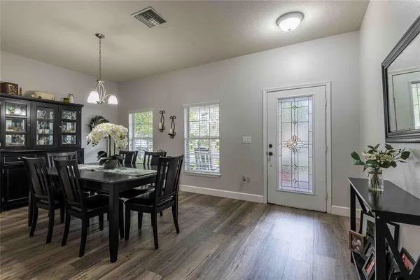 a view of a dining room with furniture window and wooden floor