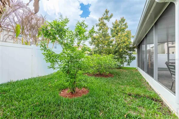 a garden with a bench in front of the house