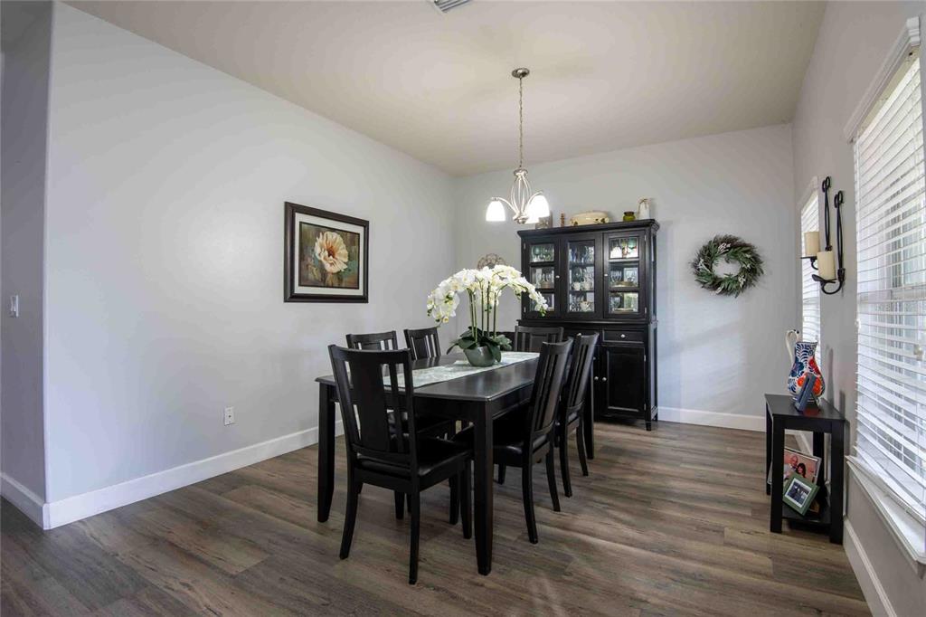 2814 Maple Brook Loop Lutz, FL 33558 - Photo 3 of 38 a view of a dining room with furniture wooden floor and chandelier