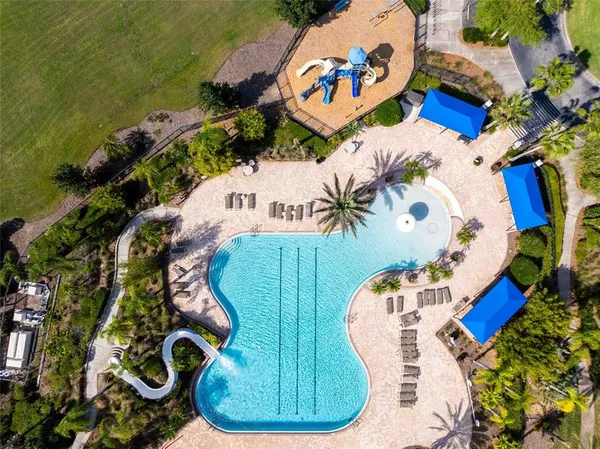 a view of a swimming pool with a table and chairs