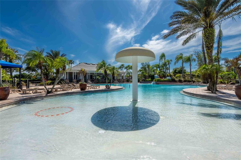 2814 Maple Brook Loop Lutz, FL 33558 - Photo 33 of 38 a view of a swimming pool with a table and chairs