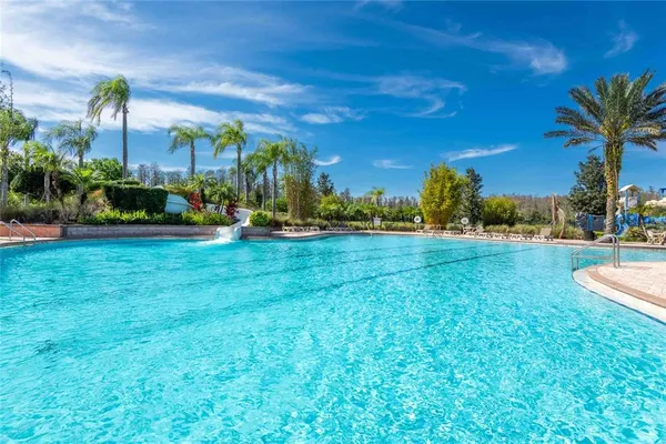 a view of swimming pool with outdoor seating and plants