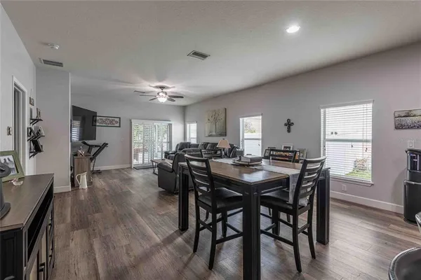 a view of a dining room with furniture and wooden floor