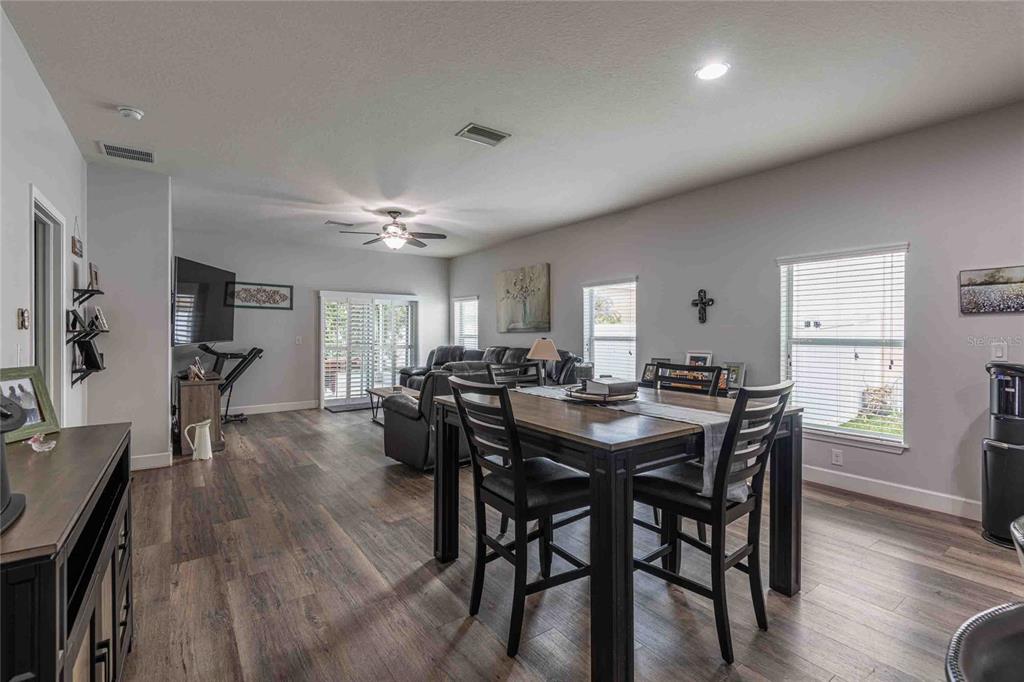 2814 Maple Brook Loop Lutz, FL 33558 - Photo 7 of 38 a view of a dining room with furniture and wooden floor