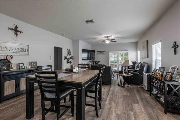 a view of a dining room with furniture and wooden floor