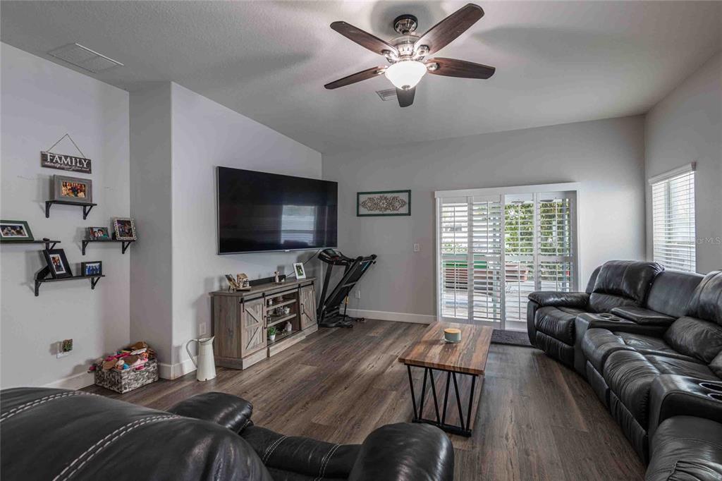 2814 Maple Brook Loop Lutz, FL 33558 - Photo 9 of 38 a living room with furniture and a flat screen tv