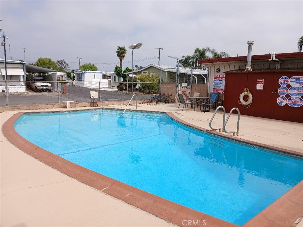 13645 5th Street, Unit 35 Yucaipa, CA 92399 - Photo 13 of 30 a view of a swimming pool with outdoor seating