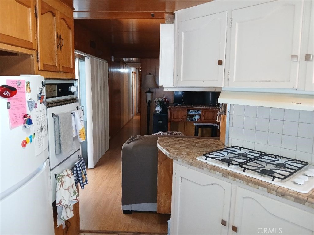 13645 5th Street, Unit 35 Yucaipa, CA 92399 - Photo 19 of 30 a kitchen with granite countertop a sink stove and refrigerator