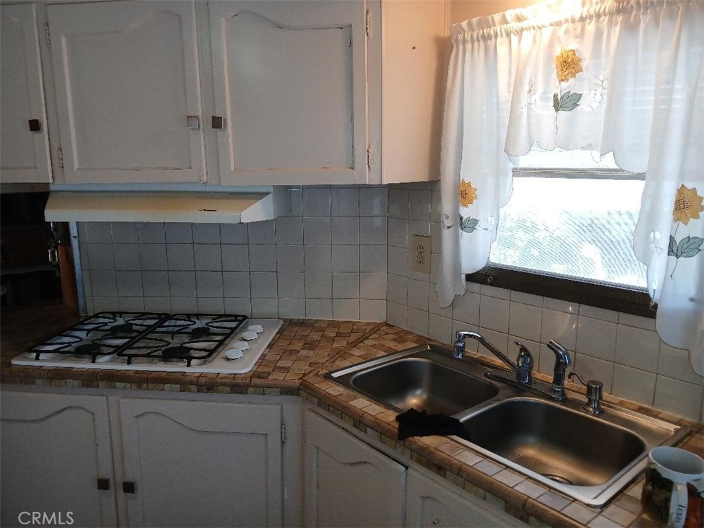 13645 5th Street, Unit 35 Yucaipa, CA 92399 - Photo 21 of 30 a kitchen that has a sink and a stove