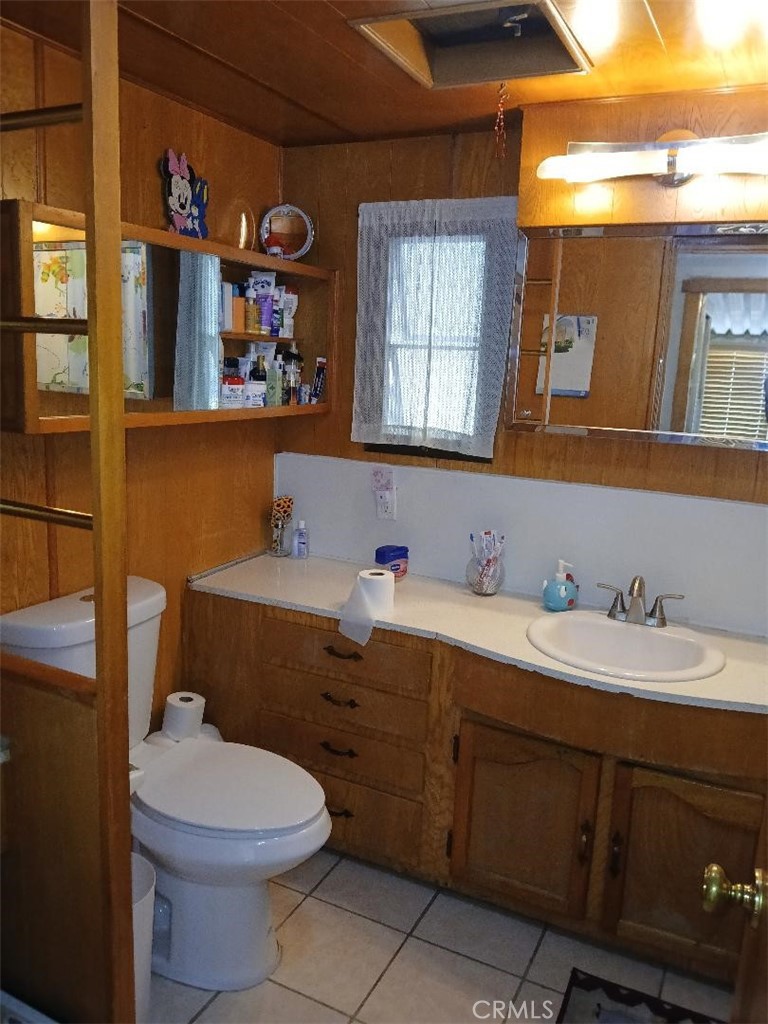 13645 5th Street, Unit 35 Yucaipa, CA 92399 - Photo 24 of 30 a bathroom with a toilet sink and mirror