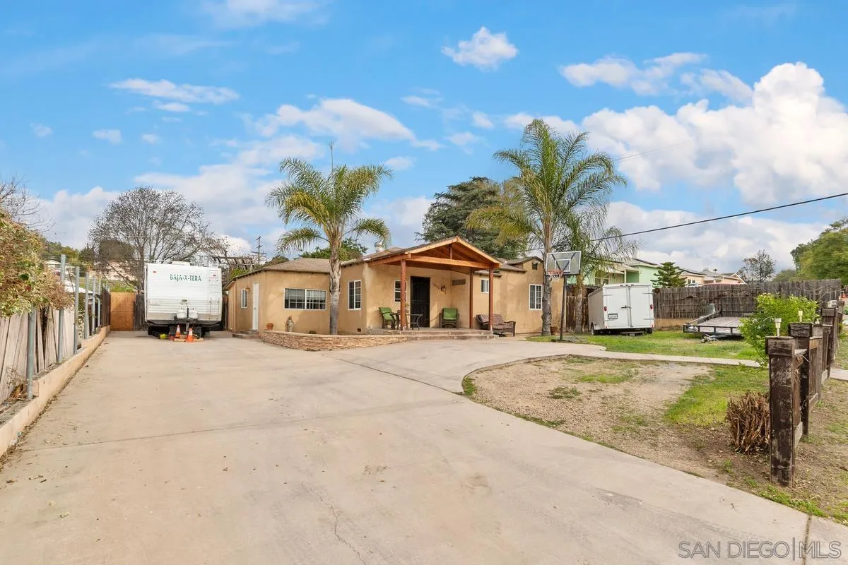 10530 Del Rio Road Spring Valley, CA 91978 - Photo 9 of 31 a front view of a house with a yard and garage