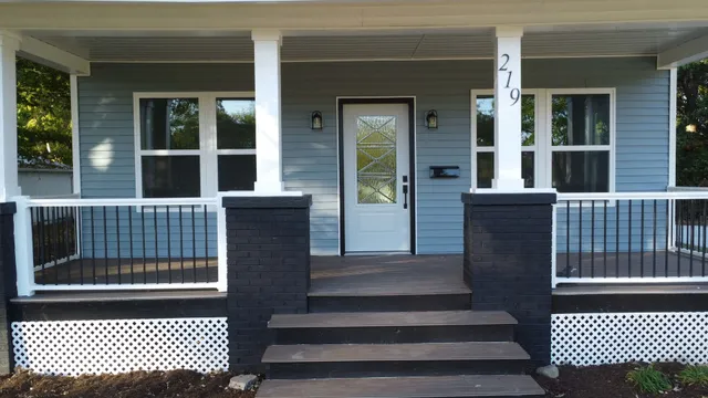 a view of a brick house with large windows