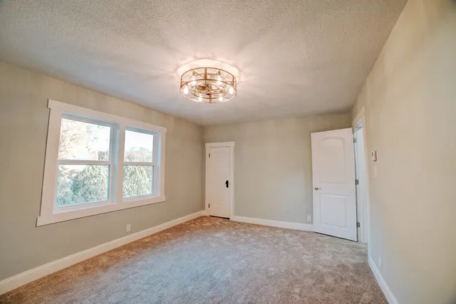 a spacious bathroom with a granite countertop sink and a mirror