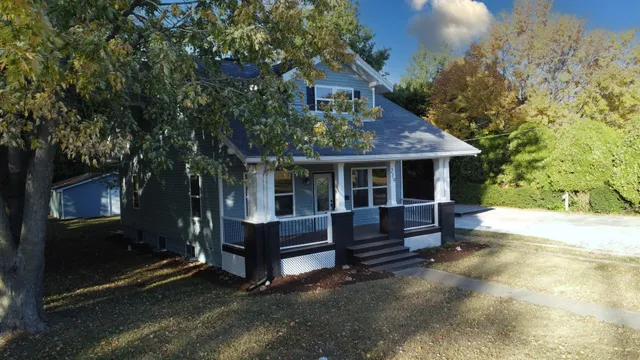a view of a house with wooden fence