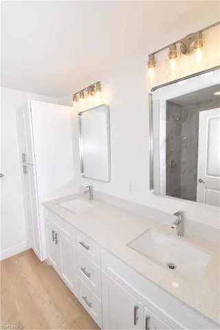 a bathroom with a double vanity sink mirror and