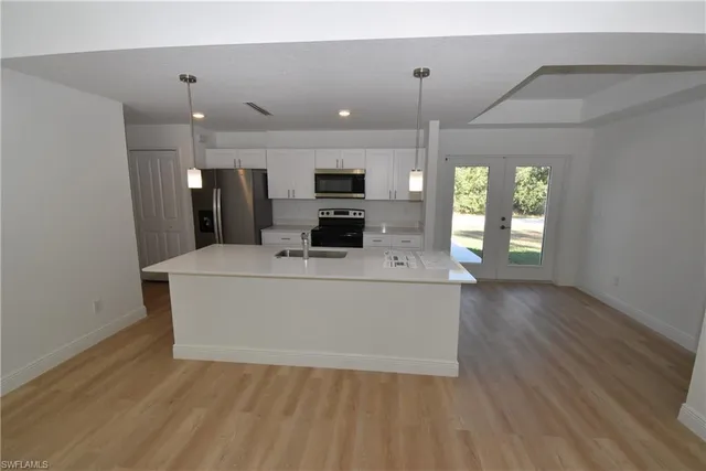 a view of kitchen with microwave and wooden floor