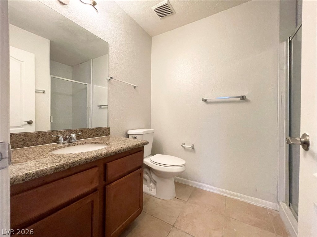 1834 North Decatur Boulevard, Unit 204 Las Vegas, NV 89108 - Photo 15 of 17 A well-appointed bathroom with a granite-topped vanity and tiled floors provides everyday comfort.