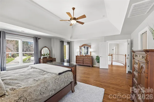 a bedroom with a bed and a large window with the outer view