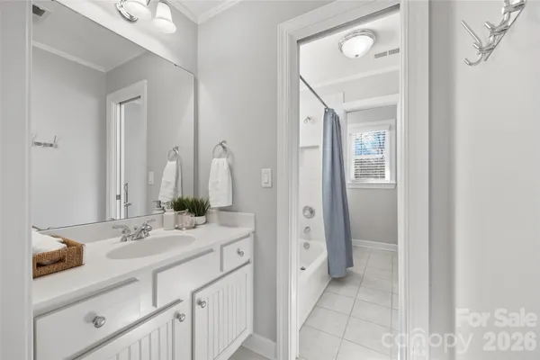 a bathroom with a double vanity sink mirror and