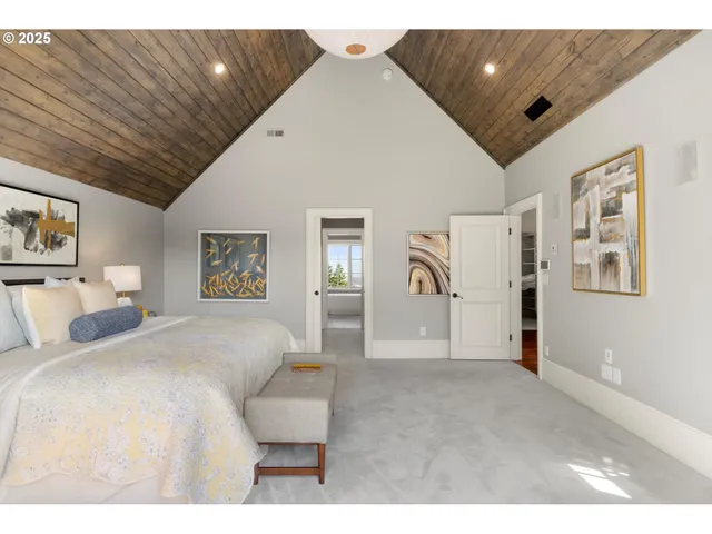 a bedroom with a large bed and a chandelier