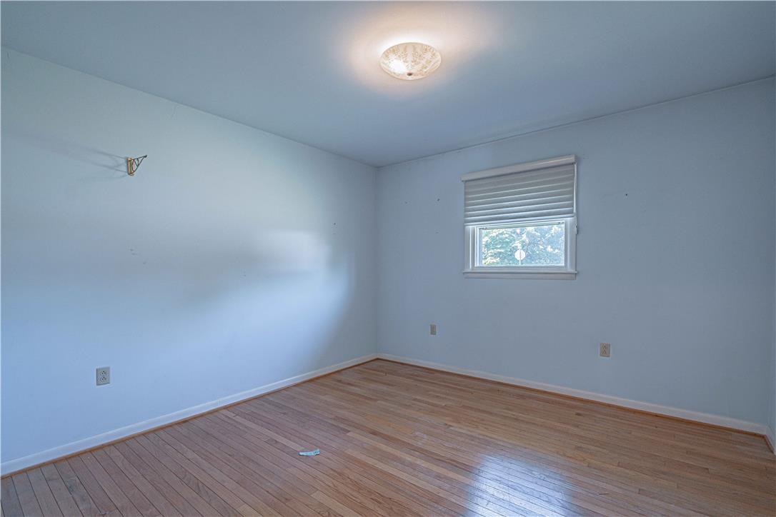 4815 Mill Road Schnecksville, PA 18078 - Photo 26 of 48 A quiet bedroom showcases light wood flooring and a single window, offering a serene personal space.