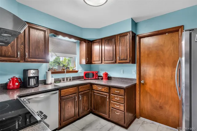 a kitchen with a sink cabinets and window