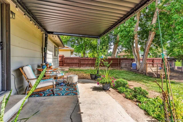 a view of a patio with table and chairs and potted plants
