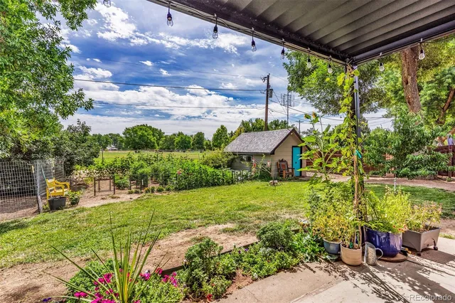 a view of a backyard with sitting area