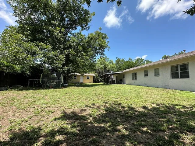 a backyard of a house with lots of green space