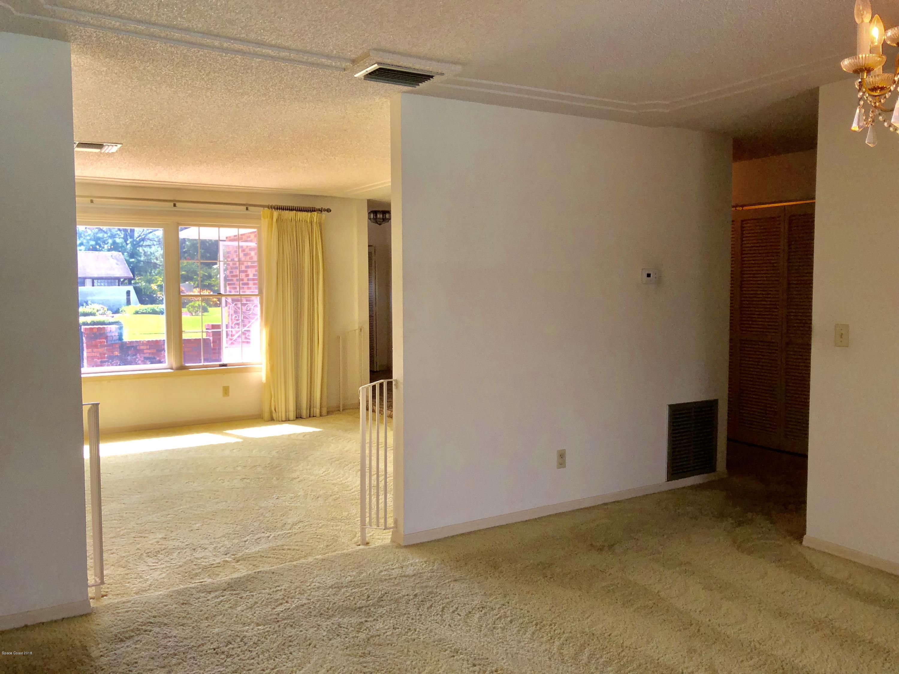 1481 Meadowbrook Road Northeast Palm Bay, FL 32905 - Photo 22 of 57 a view of an empty room with a window