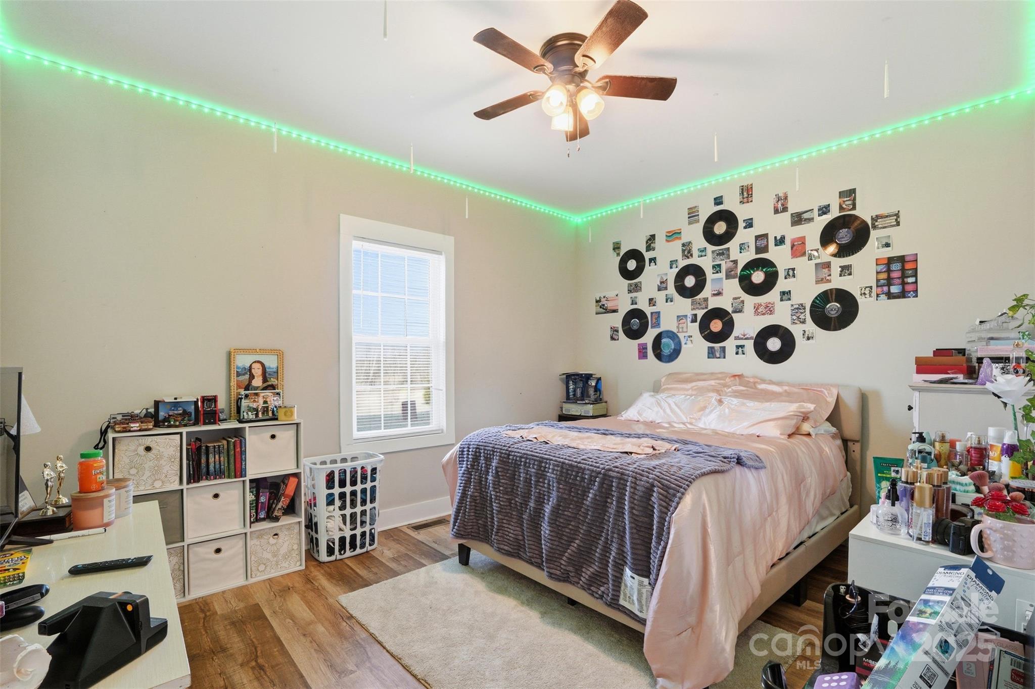 16659 Five Point Road Locust, NC 28097 - Photo 11 of 26 a bedroom with a bed and a book shelf