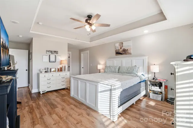 a bedroom with a bed and a chandelier