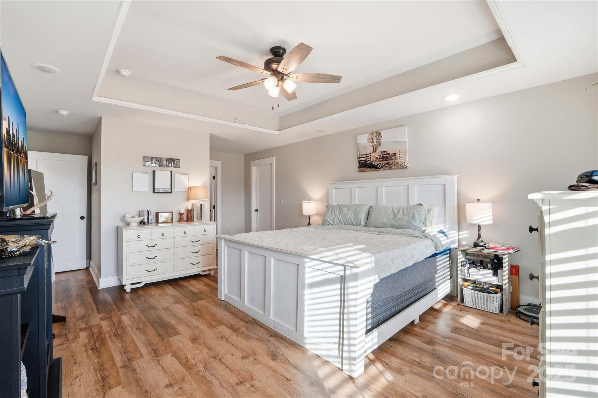 16659 Five Point Road Locust, NC 28097 - Photo 14 of 26 a bedroom with a bed and a chandelier