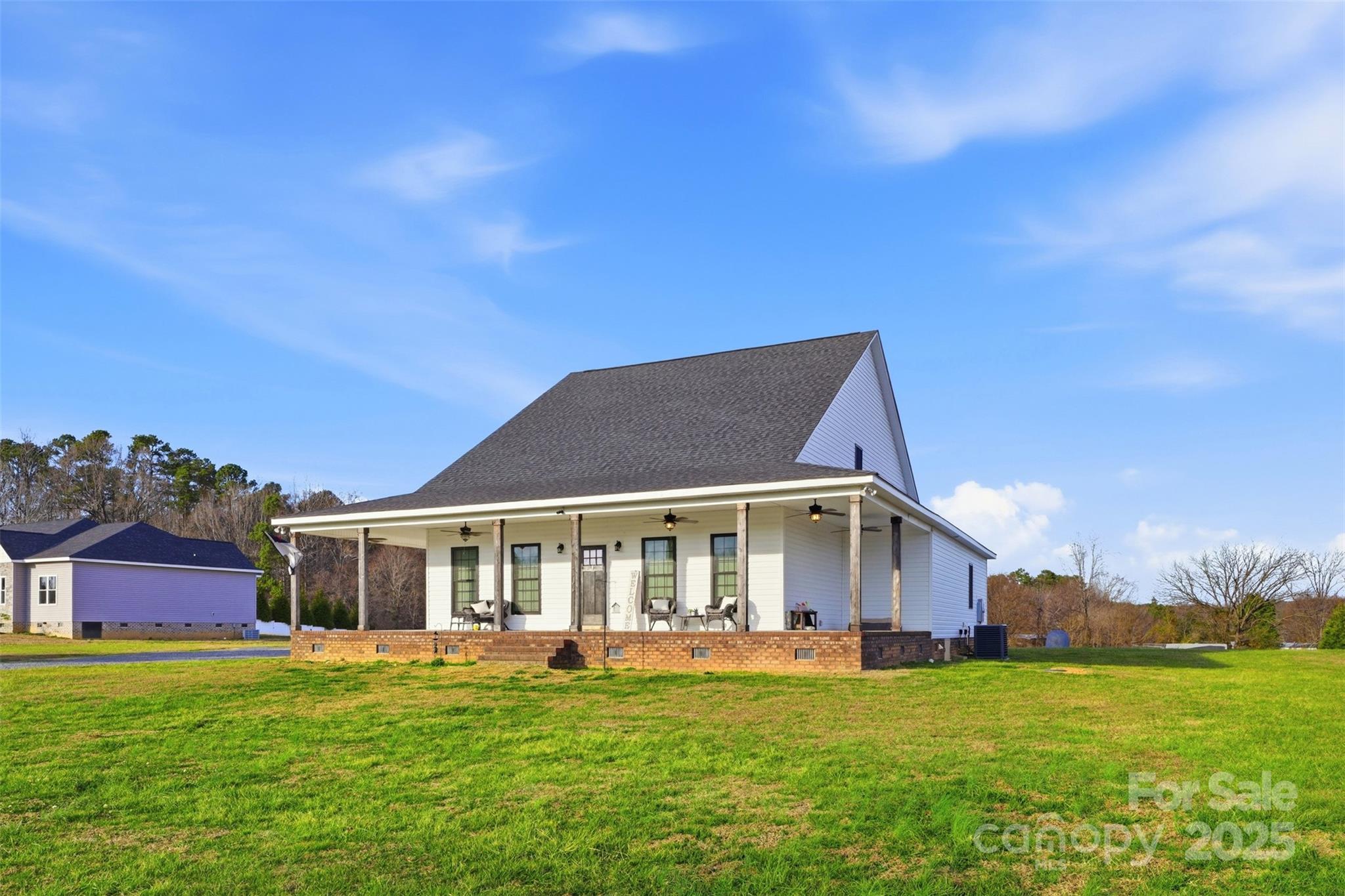 16659 Five Point Road Locust, NC 28097 - Photo 2 of 26 a front view of a house with a garden