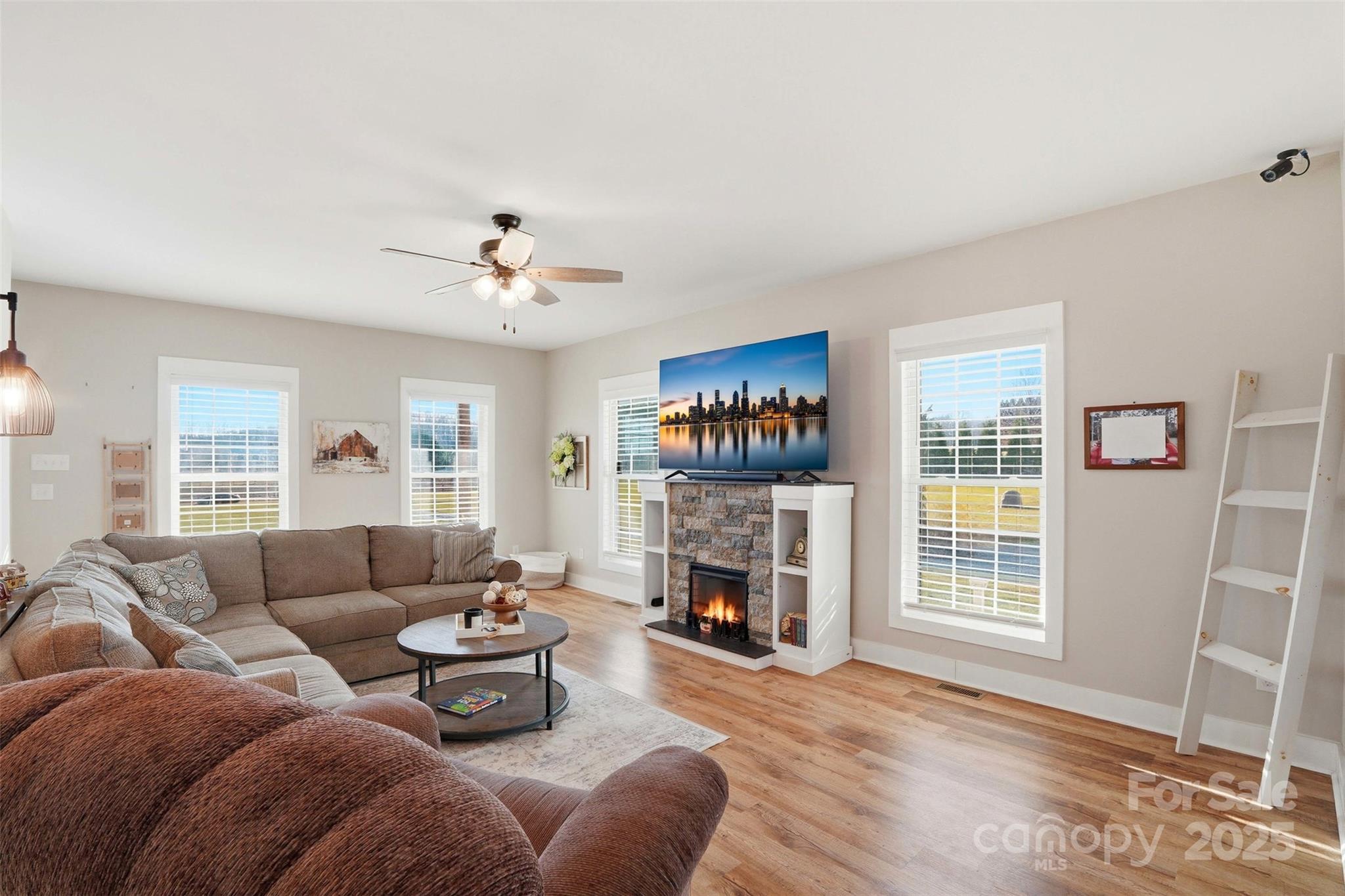 16659 Five Point Road Locust, NC 28097 - Photo 4 of 26 a living room with furniture a fireplace and a flat screen tv