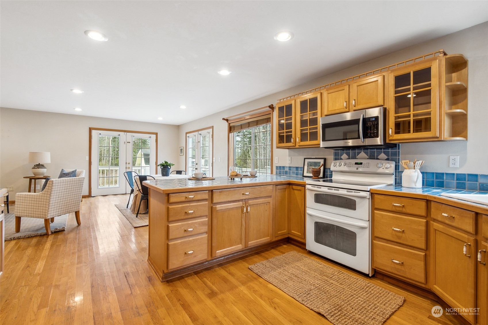 17641 Fennel Road Southeast Yelm, WA 98597 - Photo 15 of 38 a kitchen with stainless steel appliances granite countertop a stove and white cabinets