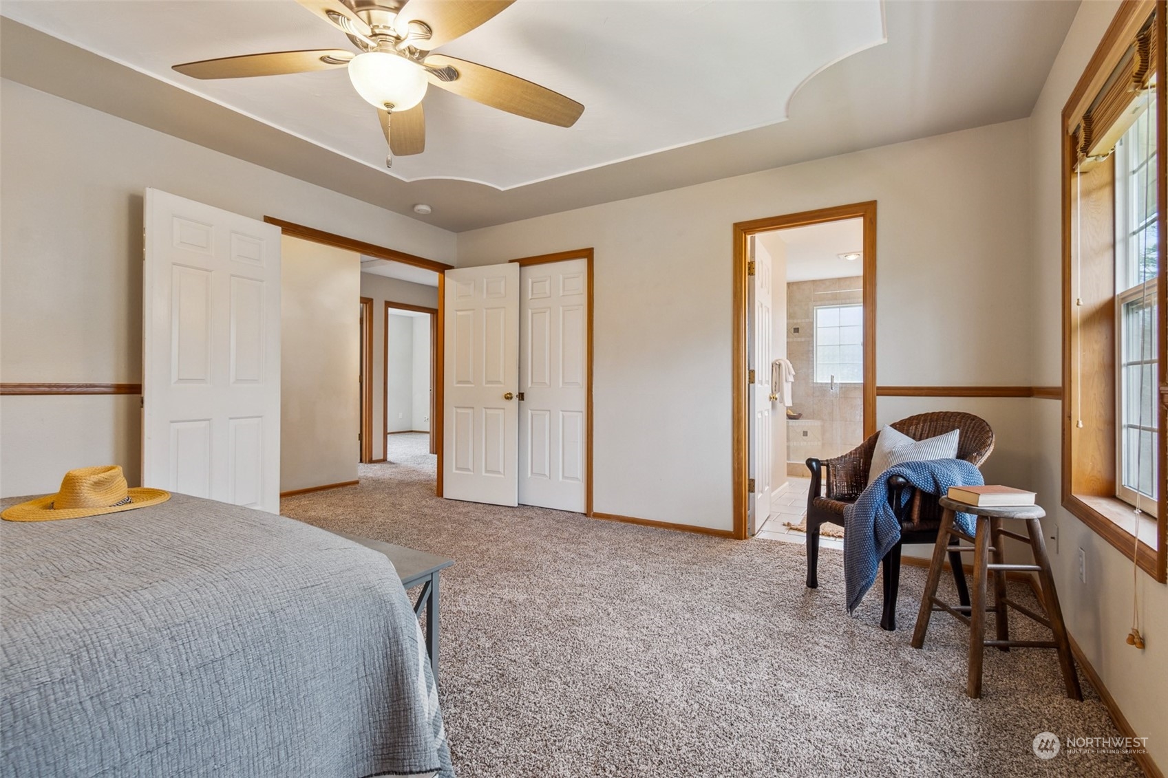 17641 Fennel Road Southeast Yelm, WA 98597 - Photo 23 of 38 a spacious bedroom with a bed and a chandelier