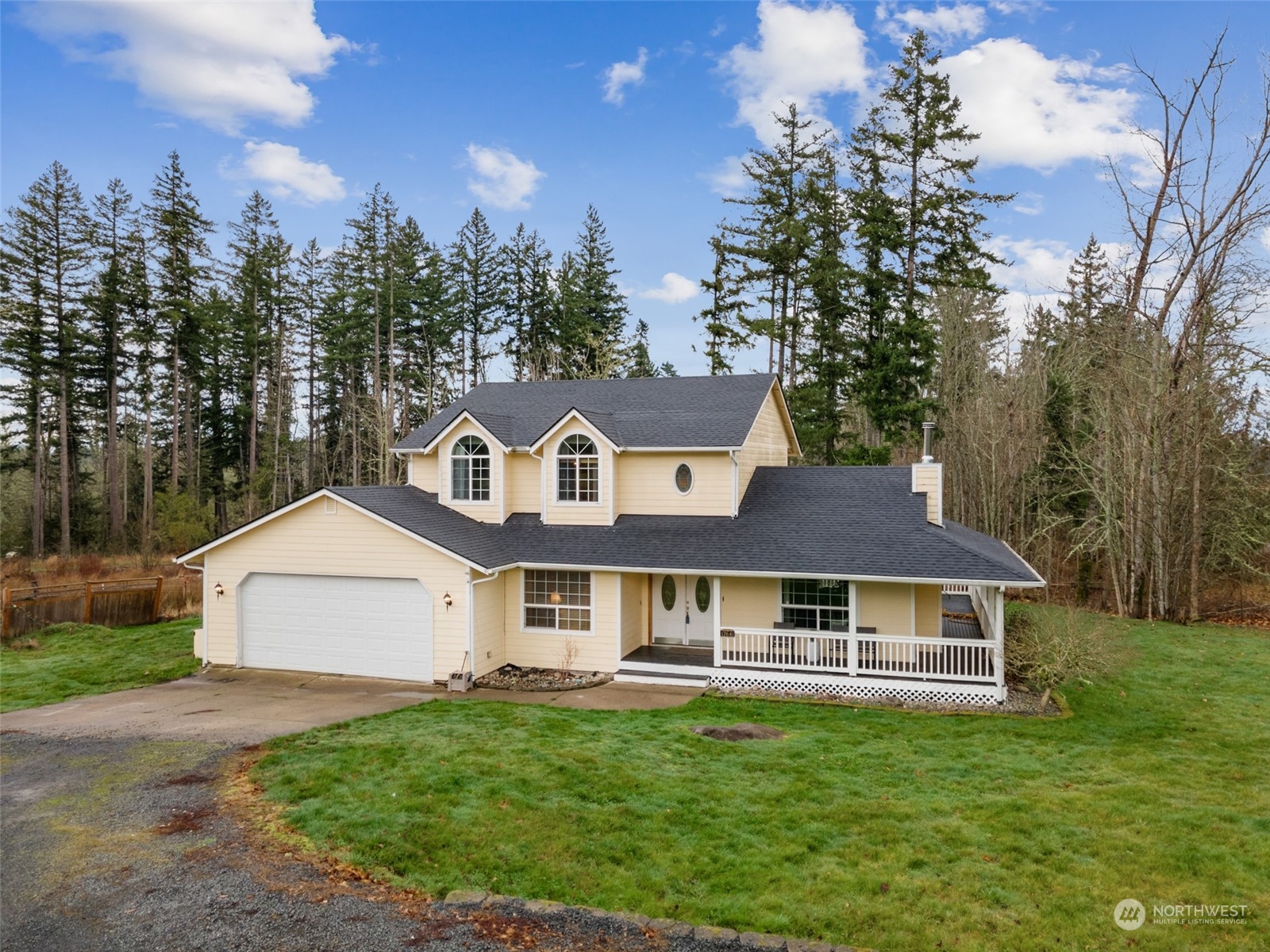 17641 Fennel Road Southeast Yelm, WA 98597 - Photo 3 of 38 a front view of a house with a yard and trees