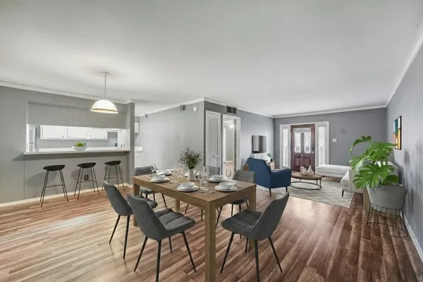 a view of a dining room with furniture and wooden floor