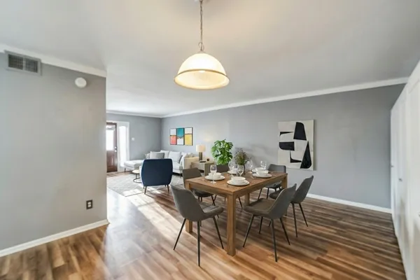 a view of a dining room with furniture and wooden floor