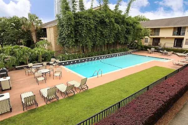 a view of a house with swimming pool and a yard