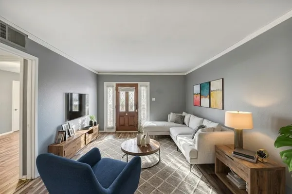 a living room with furniture and a flat screen tv