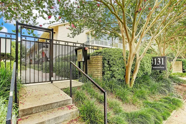 a view of balcony with floor to ceiling window and wooden fence