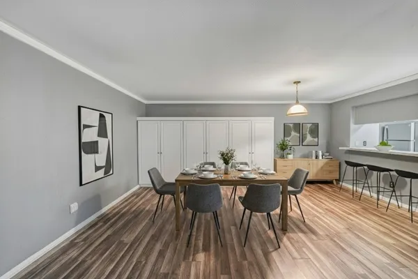 a view of a dining room with furniture and wooden floor