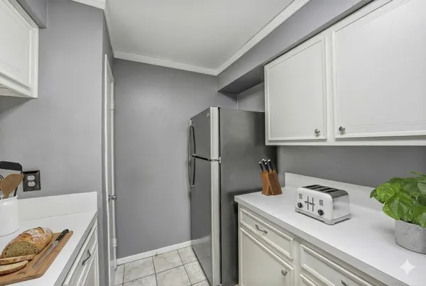 a kitchen with stainless steel appliances granite countertop a refrigerator and a sink