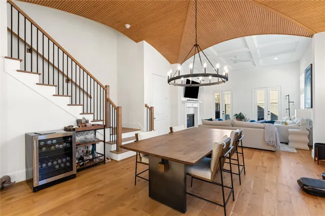 a view of a dining room with furniture wooden floor and chandelier