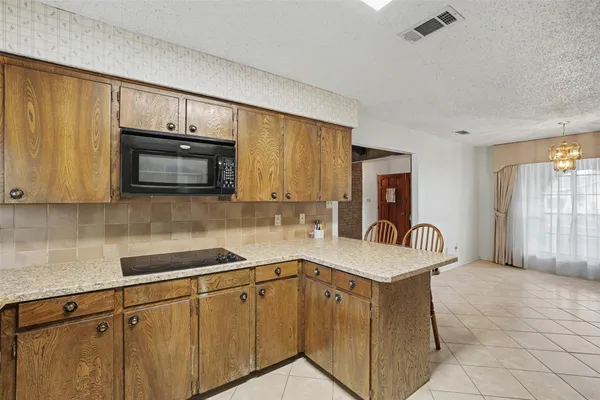 a kitchen with stainless steel appliances granite countertop a sink and a microwave