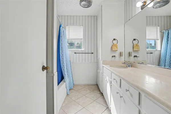 a spacious bathroom with a double vanity sink and a mirror